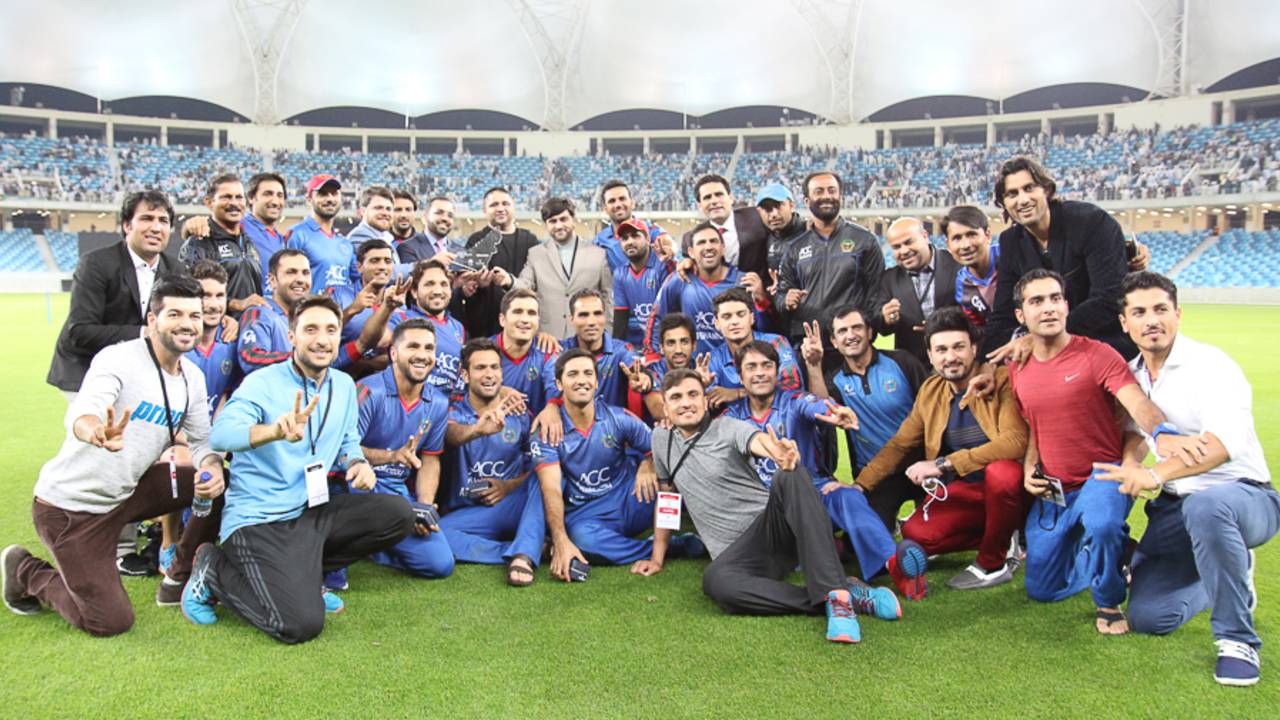 Afghanistan poses for a team photo with the tournament championship trophy