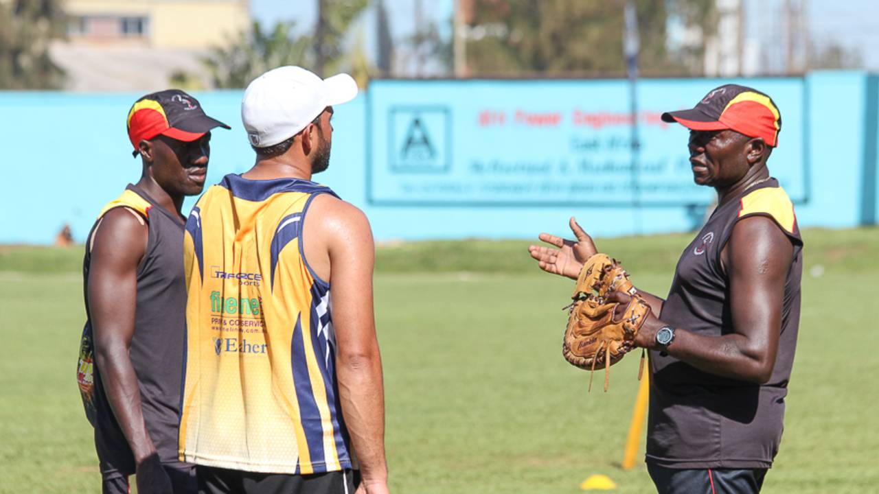 Uganda coach Steve Tikolo talks to Frank Nsubuga and Mohammed Irfan during a training session