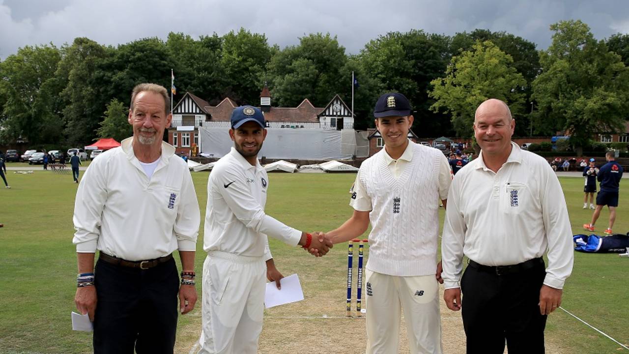 Himanshu Rana and Max Holden shake hands at the toss