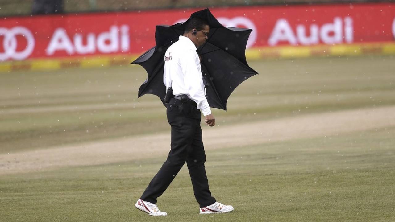 Umpire Shaun George takes shelter from rain, South Africa v Bangladesh, 1st Test, Potchefstroom, 4th day, October 1, 2017