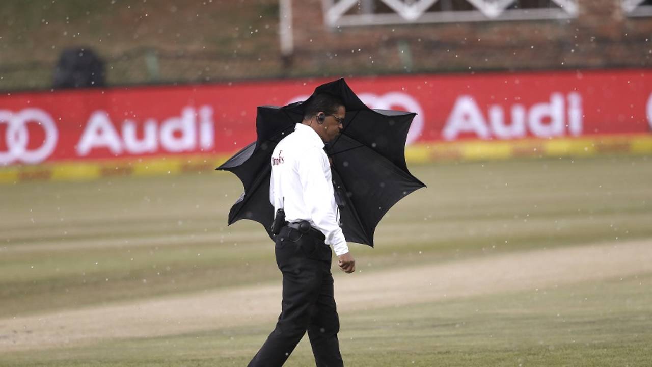 Umpire Shaun George takes shelter from rain, South Africa v Bangladesh, 1st Test, Potchefstroom, 4th day, October 1, 2017
