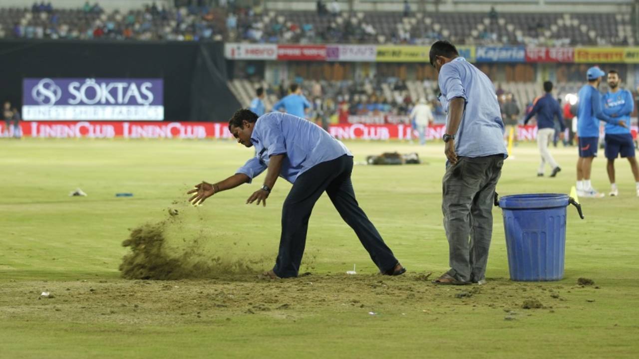 The groundstaff sprinkle sawdust on wet patches, India v Australia, 3rd T20I, Hyderabad, October 13, 2017