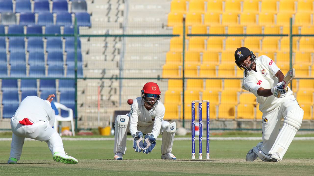 Nasir Jamal takes evasive action as Amjad Javed drives a boundary over cover
