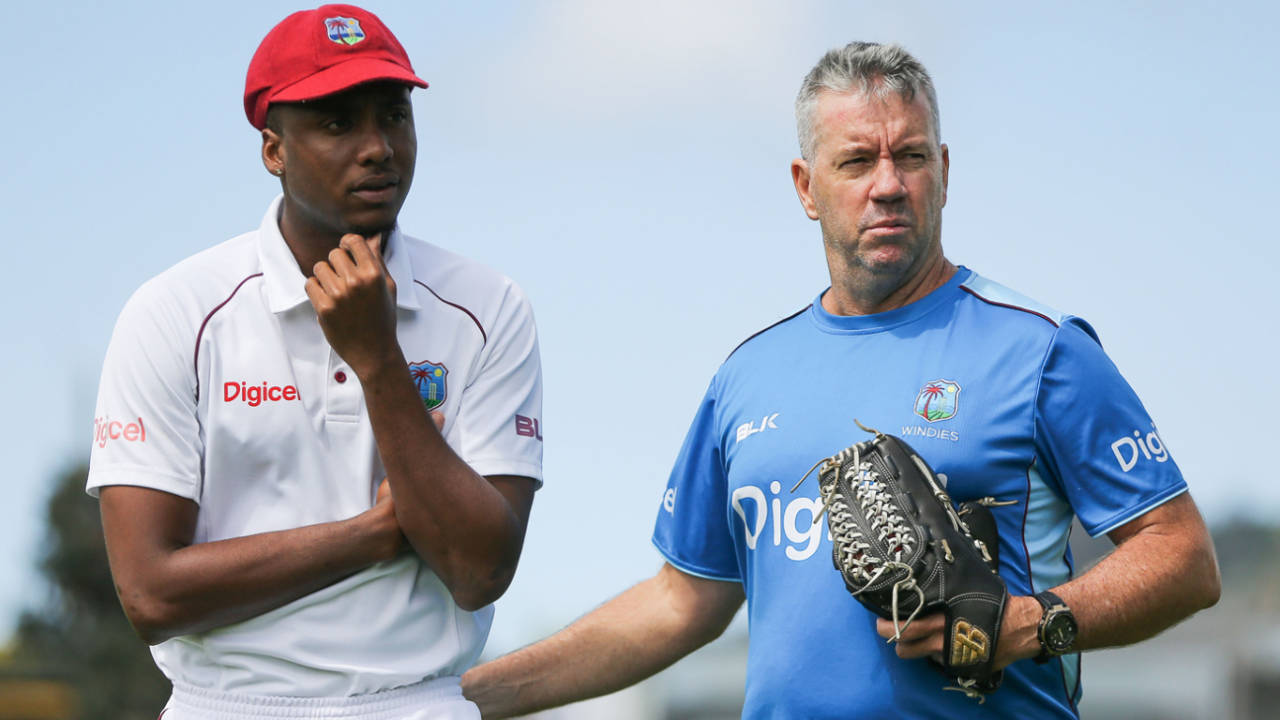 Miguel Cummins and West Indies coach Stuart Law look on after having a chat in between overs&nbsp;&nbsp;&bull;&nbsp;&nbsp;Getty Images
