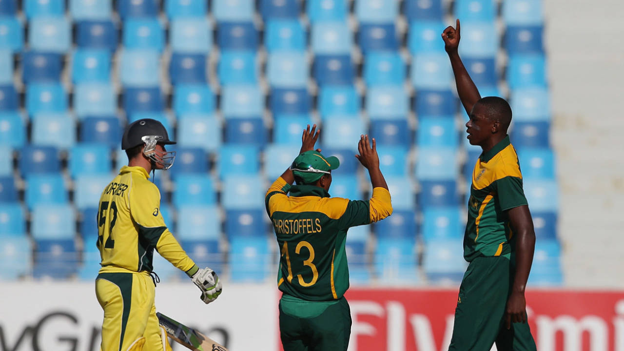 Kagiso Rabada and Kirwin Christoffels celebrate the wicket of Damien Mortimer, Australia v South Africa, semi-final, Under-19 World Cup, Dubai, February 26, 2014