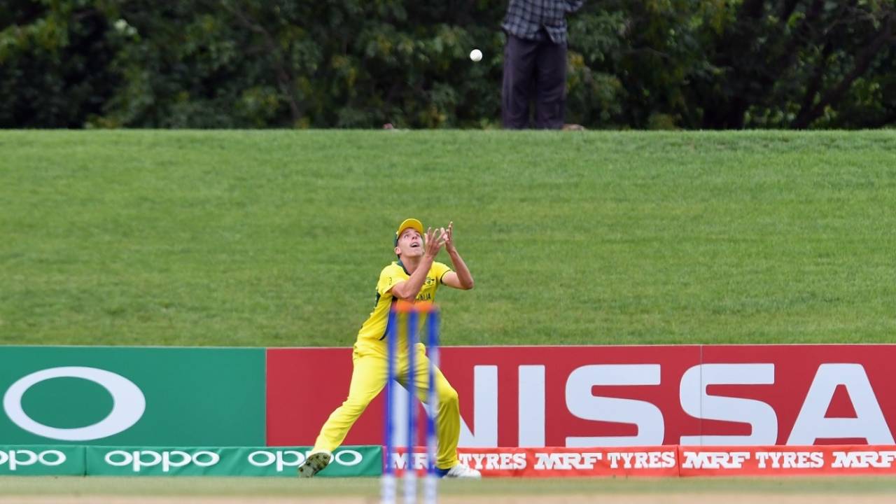 A spectator looks on as Ryan Hadley prepares to complete a catch, Australia v Afghanistan, U-19 World Cup semi-final, Christchurch, January 29, 2018