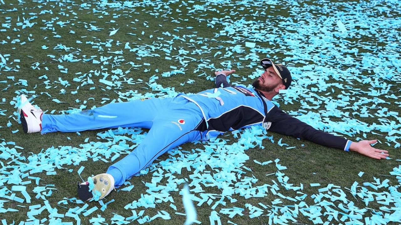 Jake Weatherald lays on a heap of confetti&nbsp;&nbsp;&bull;&nbsp;&nbsp;CA/Cricket Australia/Getty Images