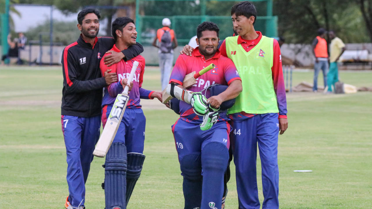 Sandeep Lamichhane and Basant Regmi are embraced by team-mates after their last-wicket stand clinched a one-wicket win, Namibia v Nepal, ICC World Cricket League Division Two, Windhoek, February 8, 2018
