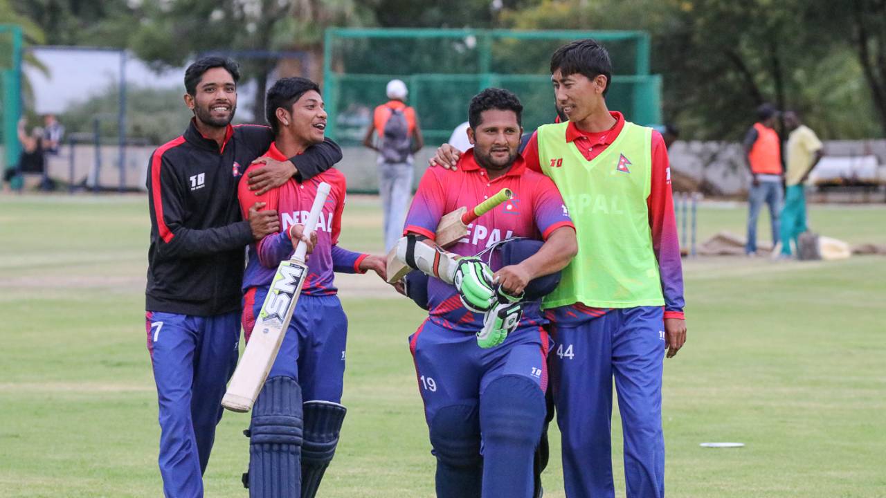 Sandeep Lamichhane and Basant Regmi are embraced by team-mates after their last-wicket stand clinched a one-wicket win, Namibia v Nepal, ICC World Cricket League Division Two, Windhoek, February 8, 2018