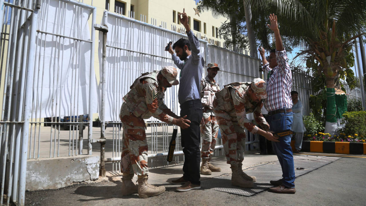Security personnel frisk people near the entrance of the National Stadium in Karachi&nbsp;&nbsp;&bull;&nbsp;&nbsp;Associated Press