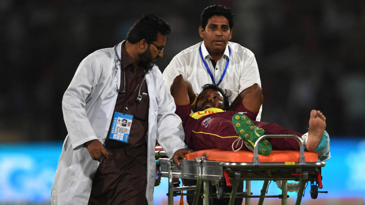Veerasammy Permaul gestures as he lies on a stretcher after being injured&nbsp;&nbsp;&bull;&nbsp;&nbsp;AFP
