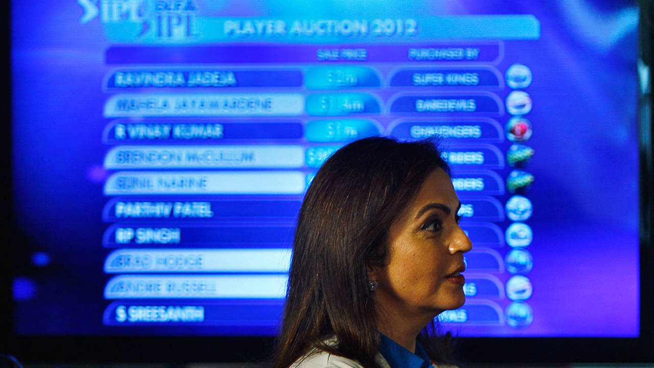 Mumbai Indians owner Nita Ambani walks past a screen displaying the players up for the IPL auction, Bangalore, February 4, 2012