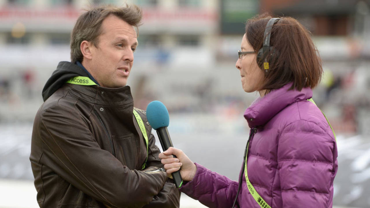 Graeme Swann huddles up in his new role behind the microphone, England v Sri Lanka, 3rd ODI, Old Trafford, May 28, 2014