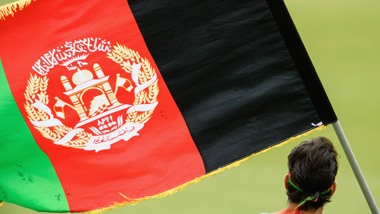 A fan flies the Afghanistan flag, January 29, 2018