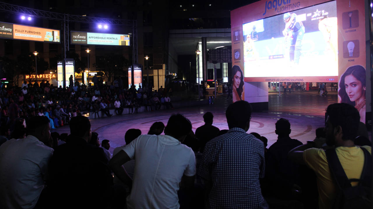 Fans watch an IPL game on a big screen in Delhi, April 7, 2018