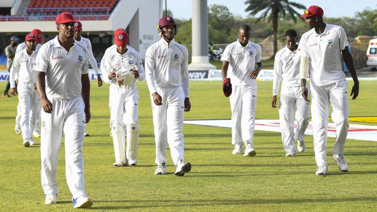 Shannon Gabriel (left) and Jason Holder (right) lead the West Indies players off the field after play, West Indies v Bangladesh, 1st Test, North Sound, 2nd day, July 5, 2018