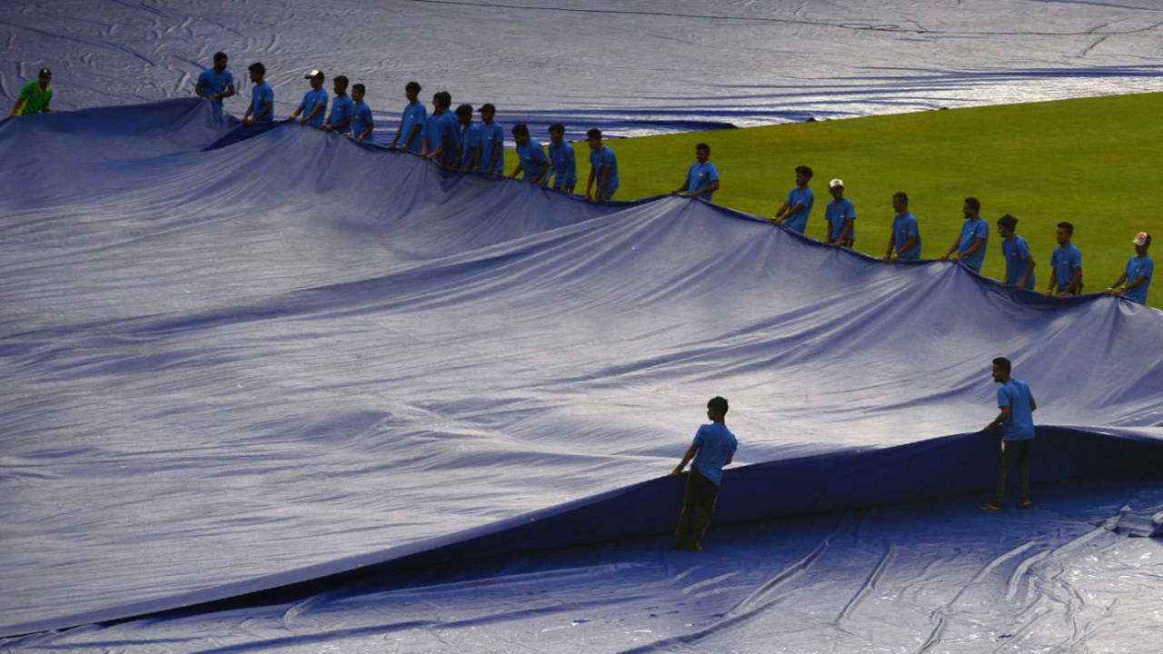 The covers were on and off as the toss was delayed&nbsp;&nbsp;&bull;&nbsp;&nbsp;AFP