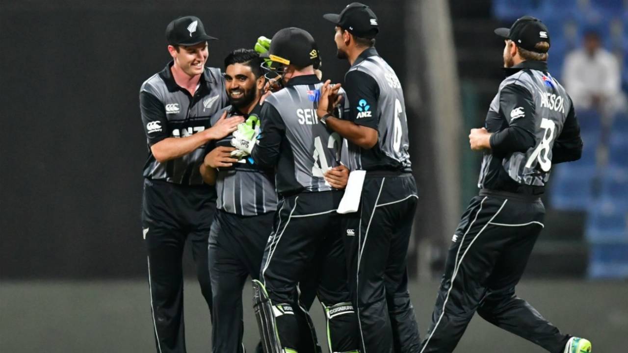 Ajaz Patel is mobbed by teammates after snaring his maiden international wicket, Pakistan v New Zealand, 1st T20I, Abu Dhabi, October 31, 2018