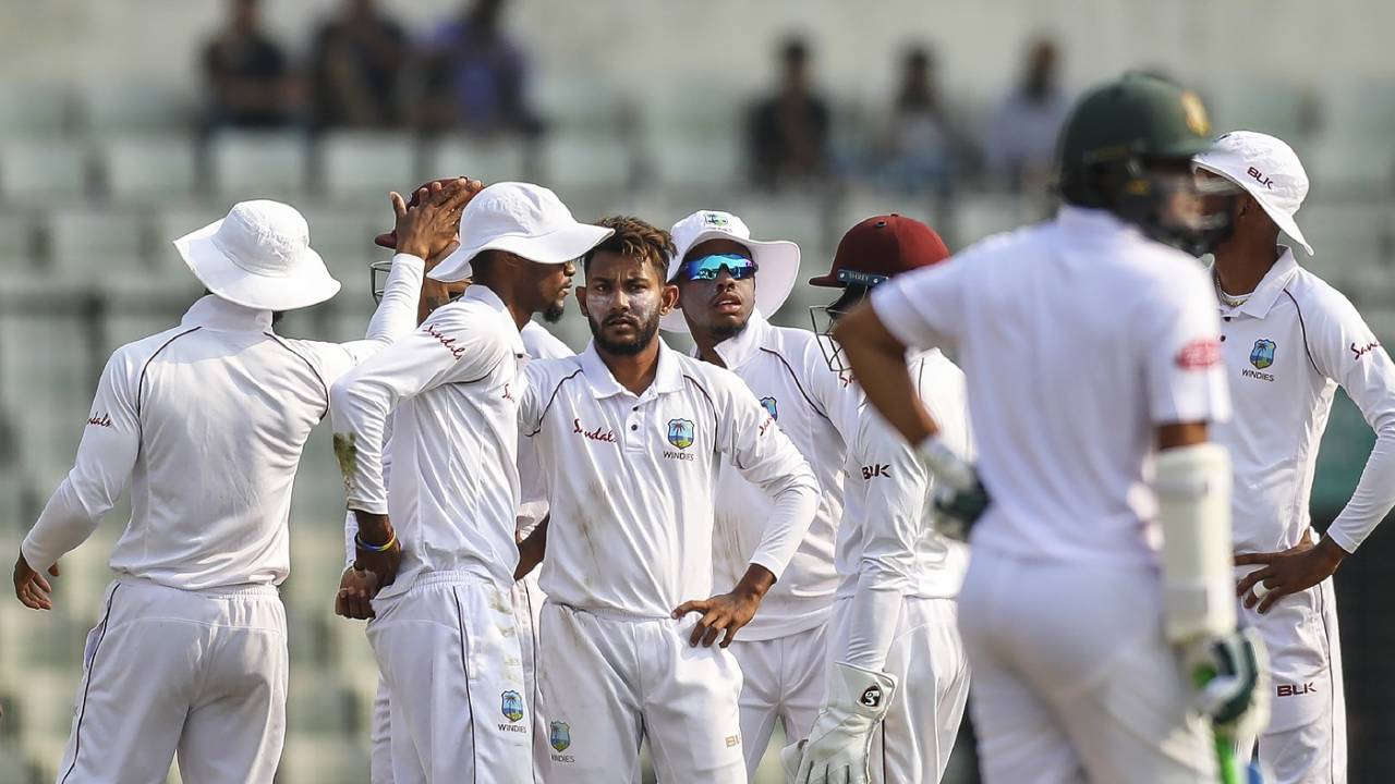 Devendra Bishoo celebrates a wicket with his team-mates