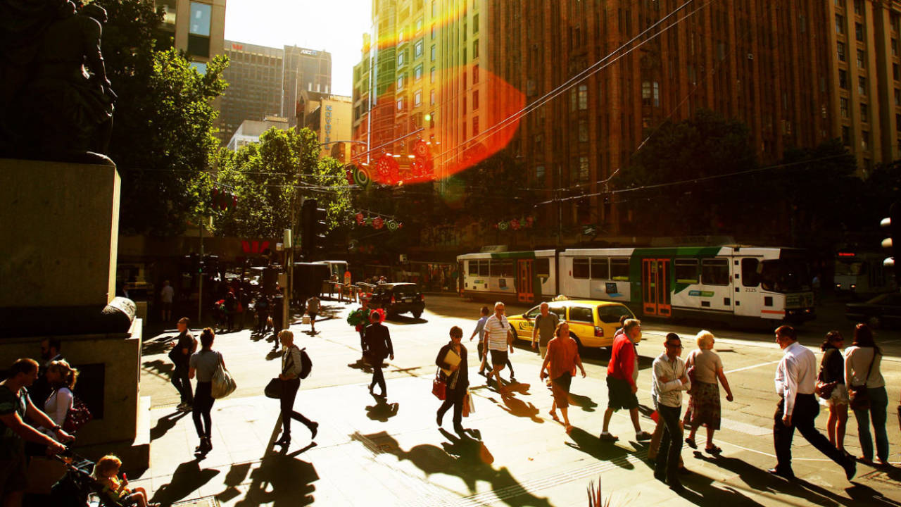 Shoppers walk along Swanston Street, Melbourne, December 20, 2012