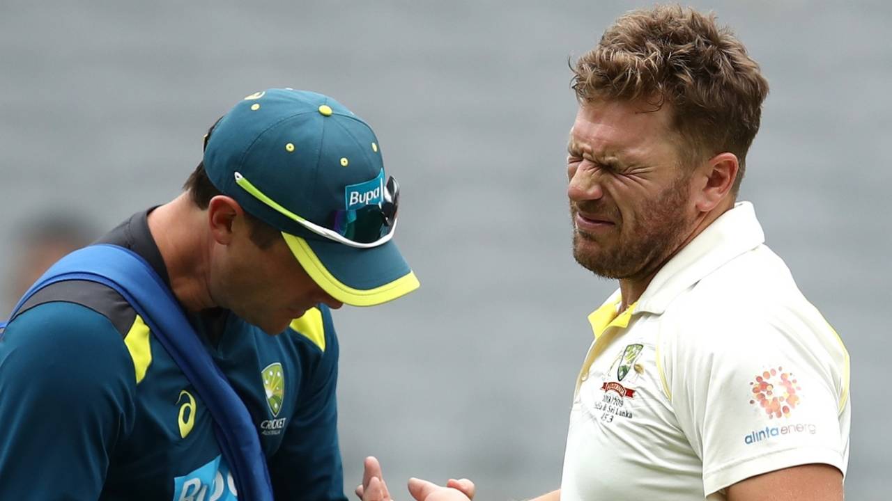 Aaron Finch in pain as the physio takes a look at his injury, Australia v India, 2nd Test, Perth, 3rd day, December 16, 2018