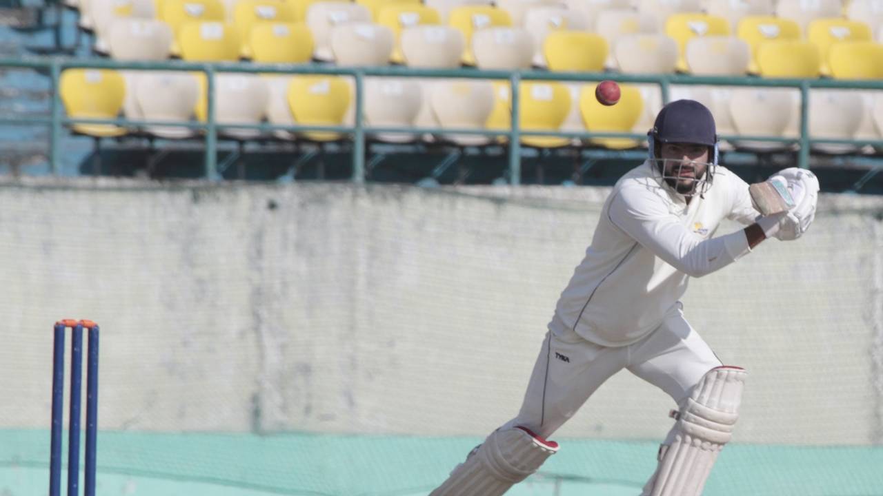 Raghav Dhawan punches the ball