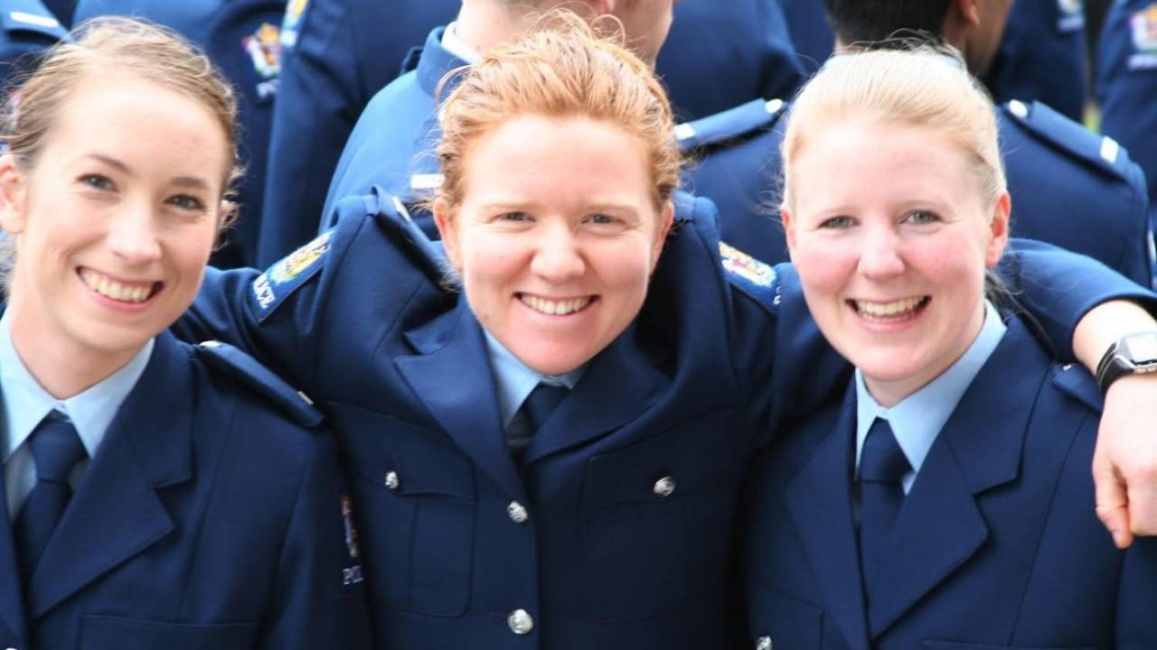 Katie Perkins (centre) served as a Youth Engagement Officer with the Auckland Police Department