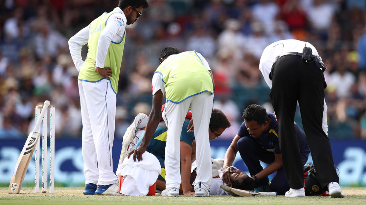 Sri Lanka's physio checks on Dimuth Karunaratne after he is hit on the head by a Pat Cummins bouncer&nbsp;&nbsp;&bull;&nbsp;&nbsp;Getty Images