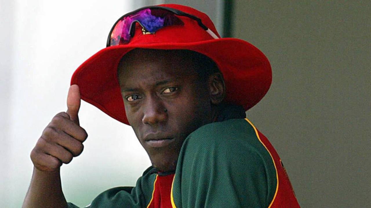 Henry Olonga wears a black armband in protest while in the players' enclosure,  Zimbabwe v Namibia, Harare, 10 February 2003