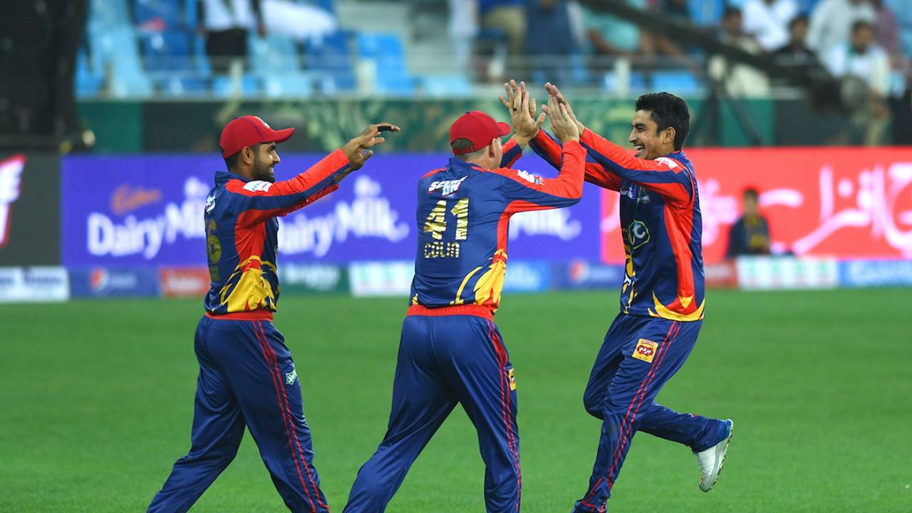 Umer Khan celebrates a wicket with his team-mates
