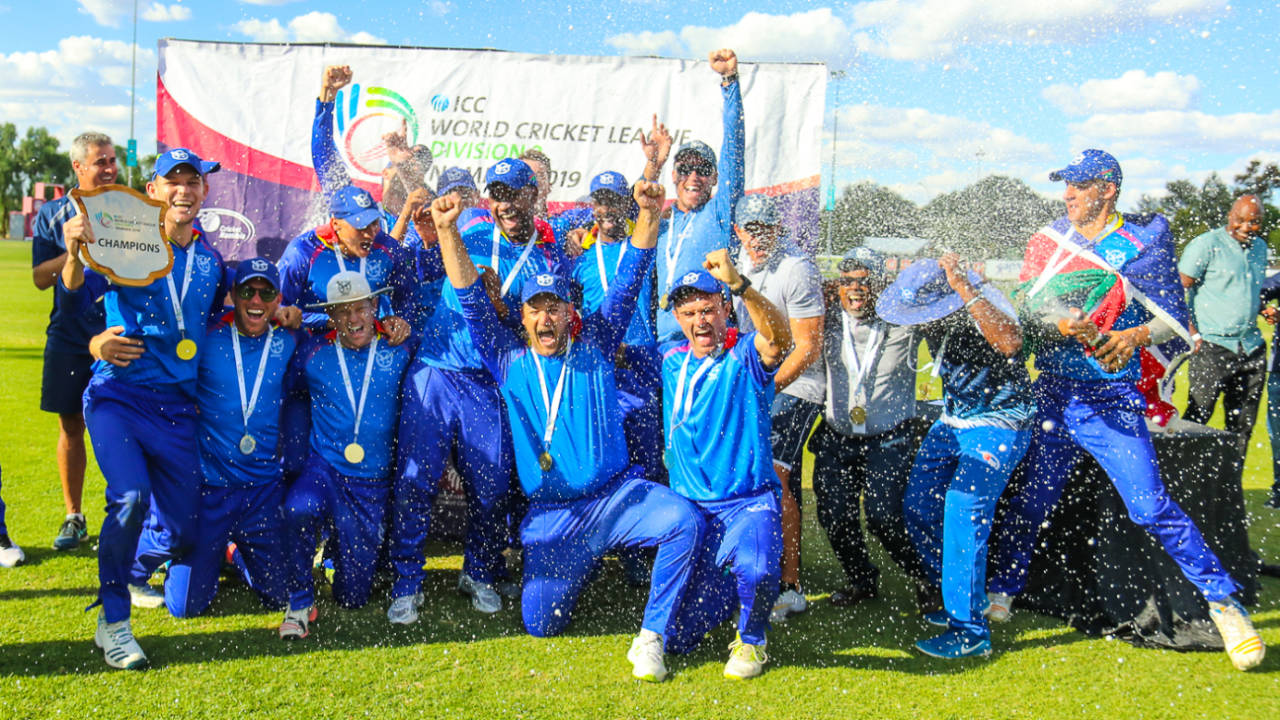Namibia captain Gerhard Erasmus holds the WCL Division Two trophy aloft during champagne celebrations, Namibia v Oman, WCL Division Two, Final, Windhoek, April 27, 2019
