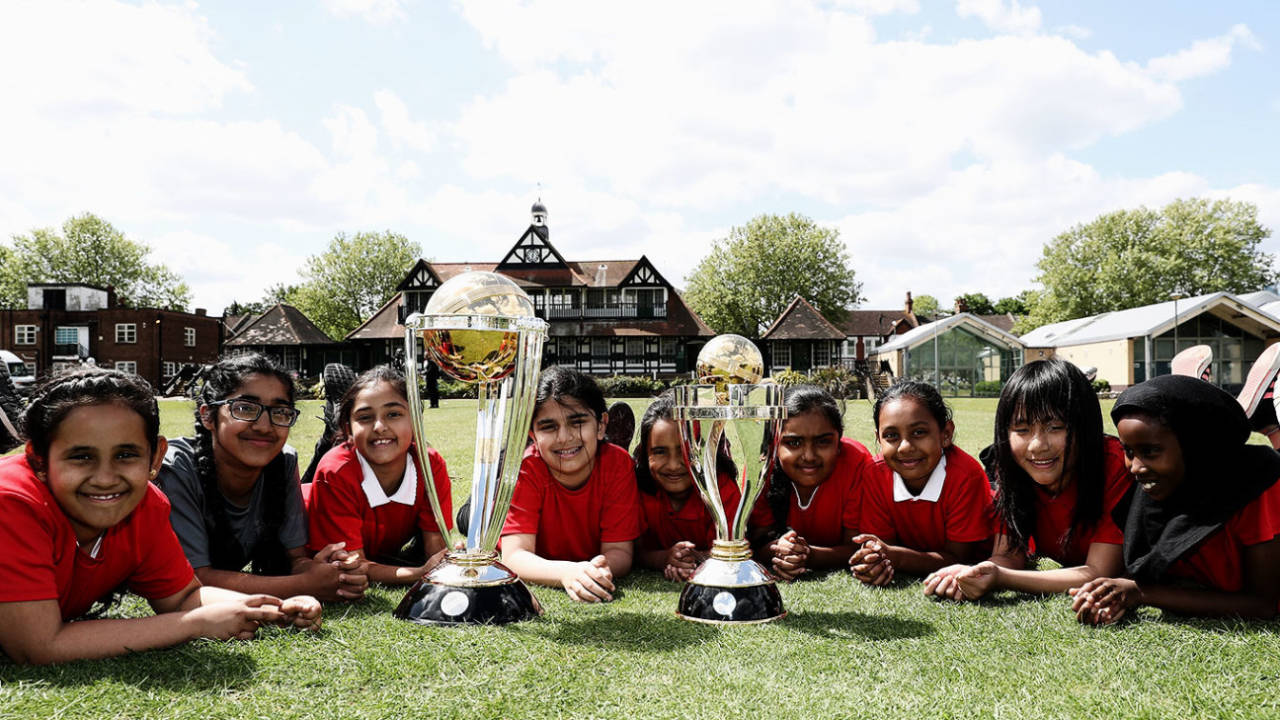 Kids pose with the ICC men's and women's World Cup trophies, Leyton, May 10, 2018