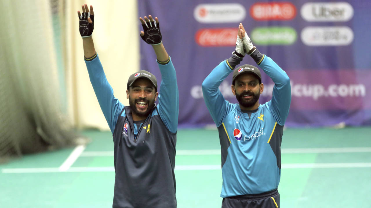 Mohammad Amir and Mohammad Hafeez cheer their team-mates during a nets session&nbsp;&nbsp;&bull;&nbsp;&nbsp;AFP