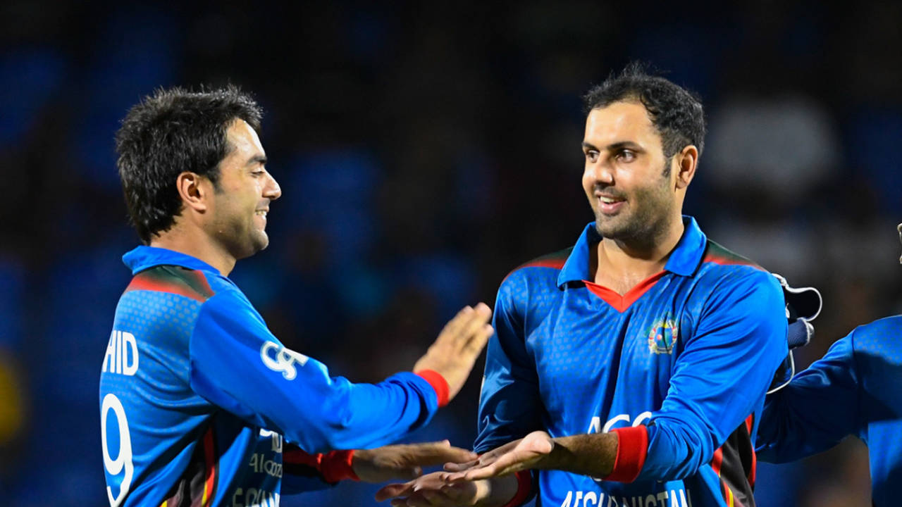 Rashid Khan (left) and Mohammad Nabi celebrate the dismissal of Chadwick Walton, West Indies v Afghanistan, 2nd T20I, St Kitts, June 3, 2017