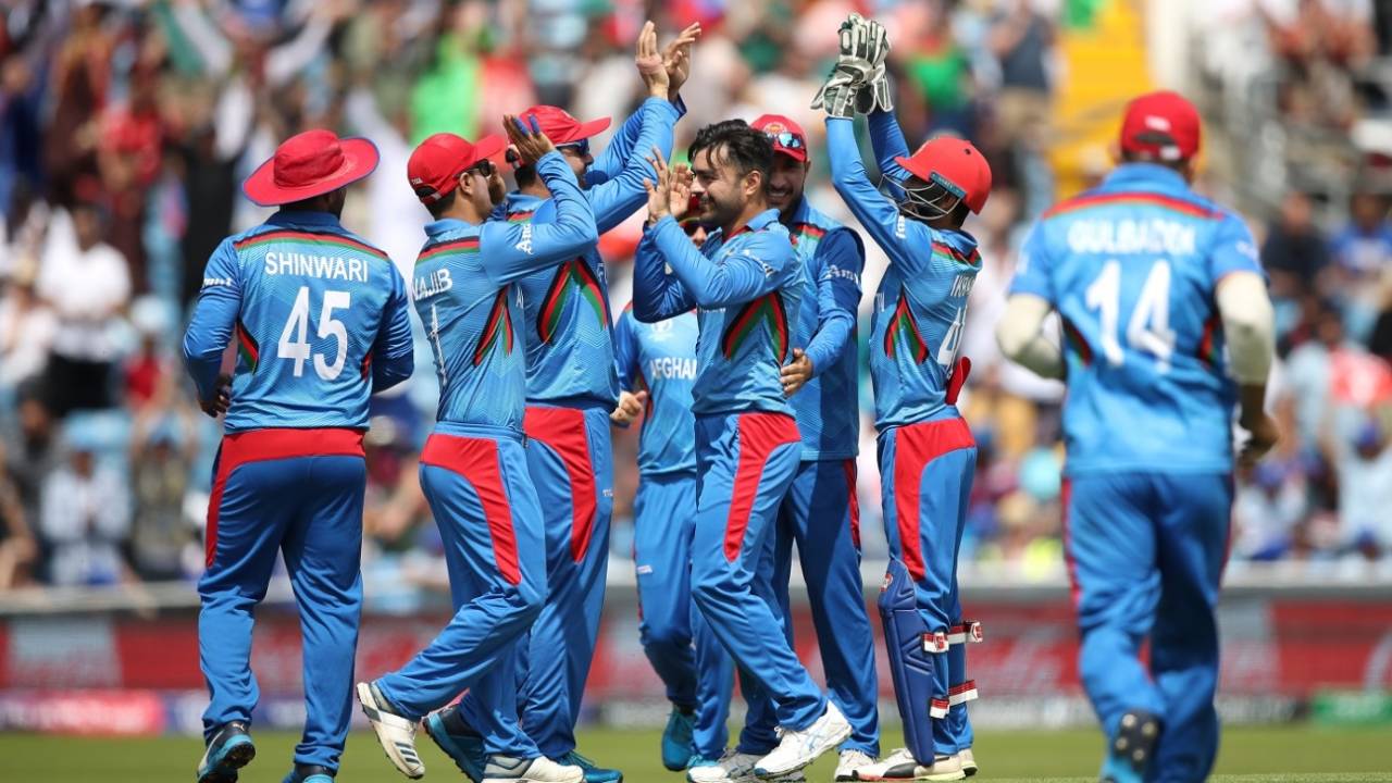 Rashid Khan celebrates dismissing Evin Lewis with his teammates, Afghanistan v West Indies. World Cup 2019, Headingley, July 4, 2019