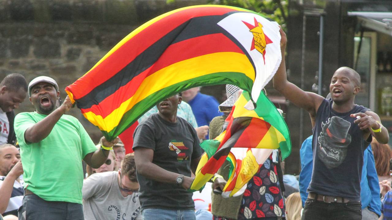 Visiting fans unfurl the Zimbabwe flag after victory is secured&nbsp;&nbsp;&bull;&nbsp;&nbsp;Peter Della Penna