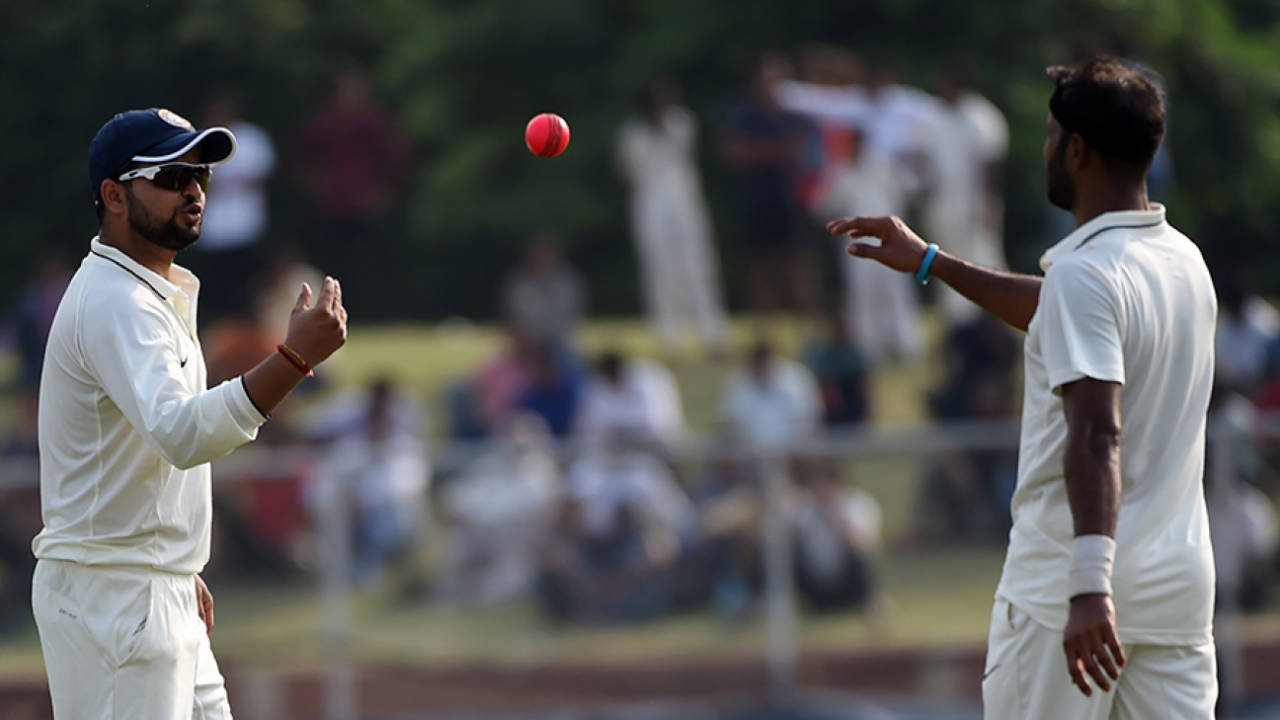 Suresh Raina tosses the pink ball to Ashok Dinda during the 2016-17 Duleep Trophy