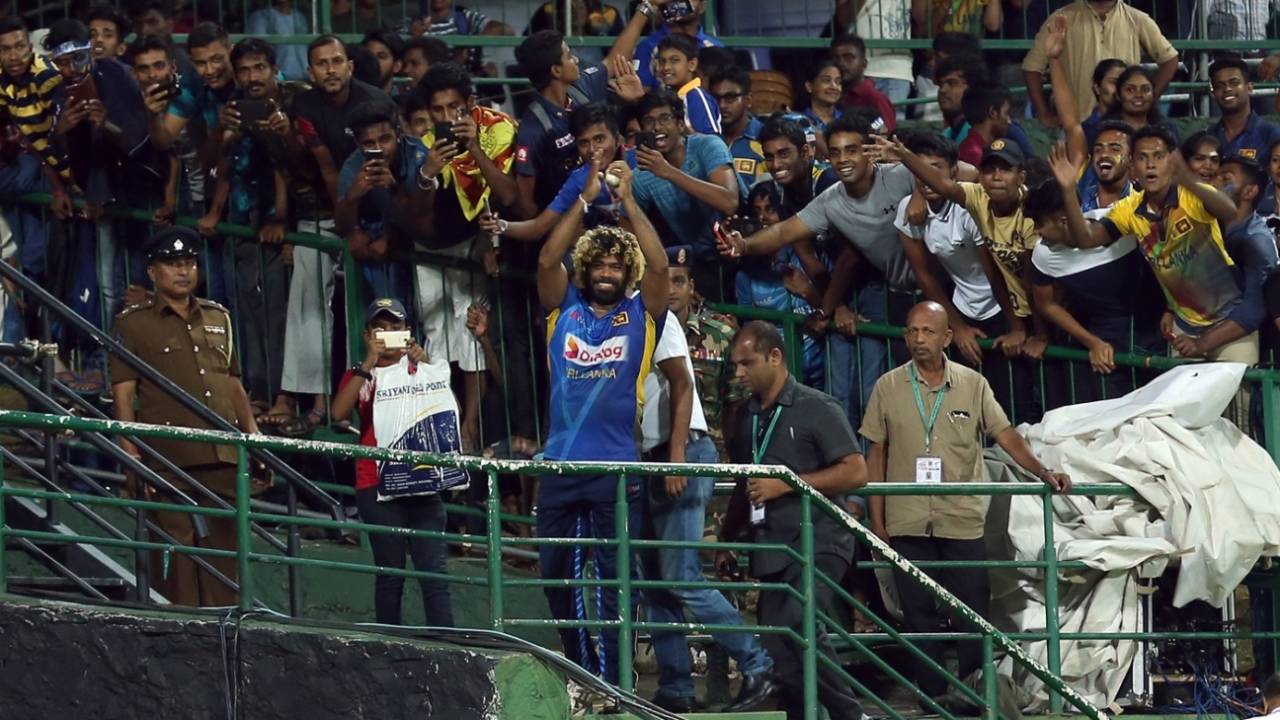 Lasith Malinga celebrates the feat with fans in Pallekele&nbsp;&nbsp;&bull;&nbsp;&nbsp;Getty Images