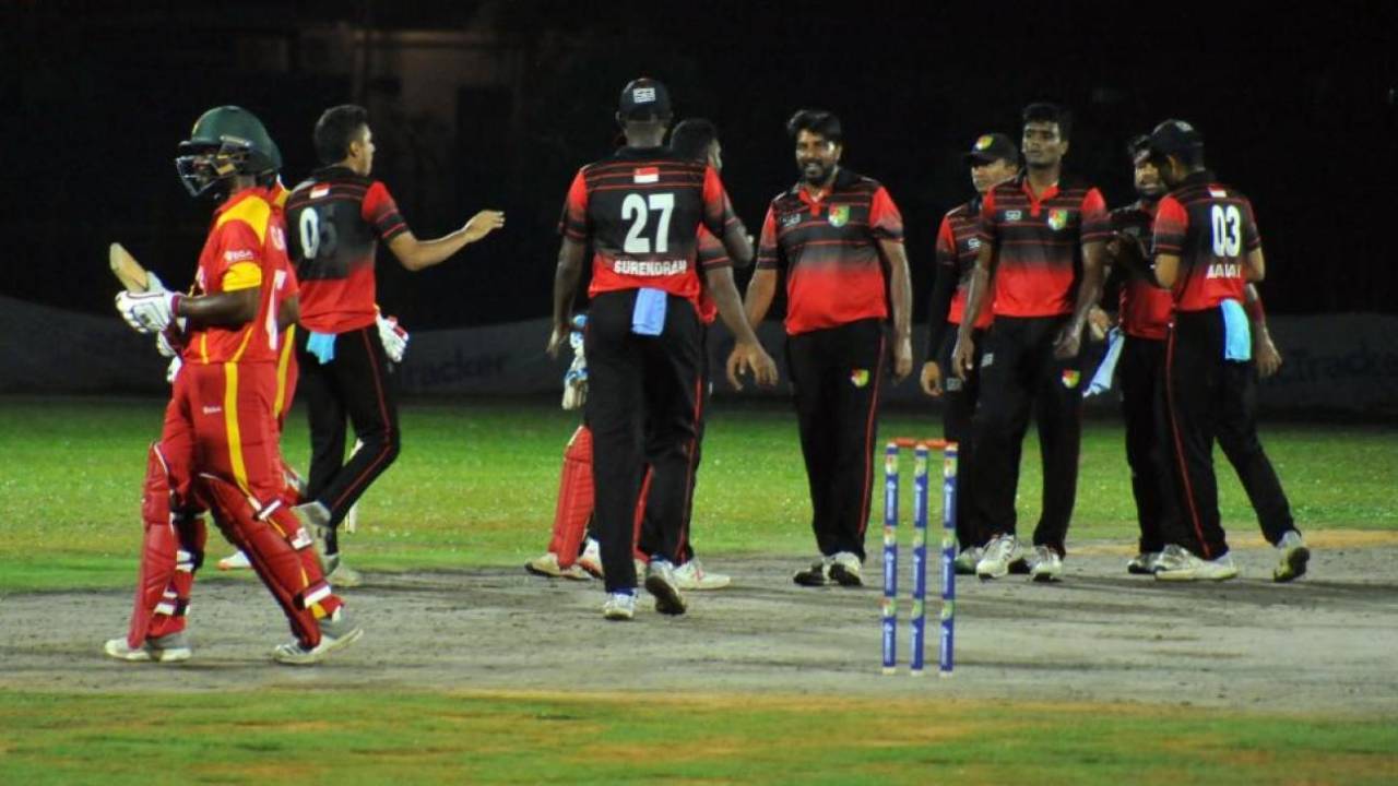 Amjad Mahboob, the Singapore captain, celebrates the wicket of Brian Chari,
