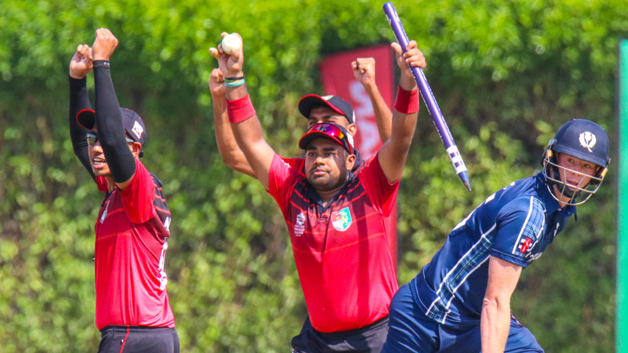 Singapore's Aritra Dutta rips out the stumps with ball in hand to end the match, Scotland v Singapore, T20 World Cup Qualifier, Dubai, October 18, 2019