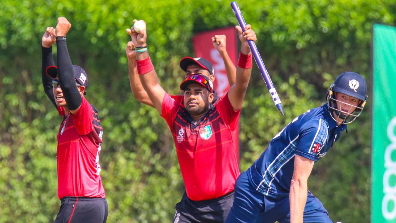 Singapore's Aritra Dutta rips out the stumps with ball in hand to end the match