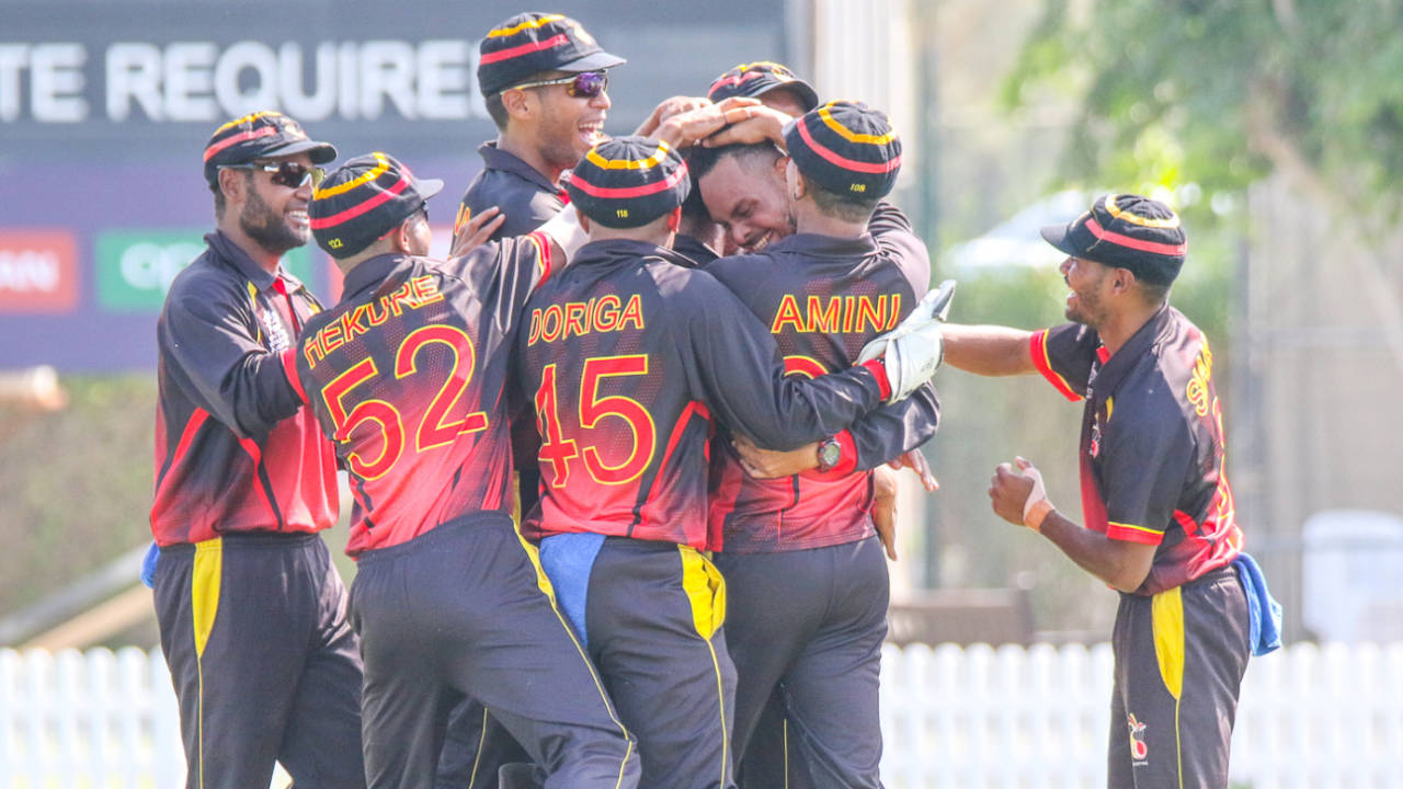 Norman Vanua is mobbed after taking a hat-trick against Bermuda in PNG's opening match, Bermuda v Papua New Guinea, T20 World Cup Qualifier, Dubai, October 19, 2019