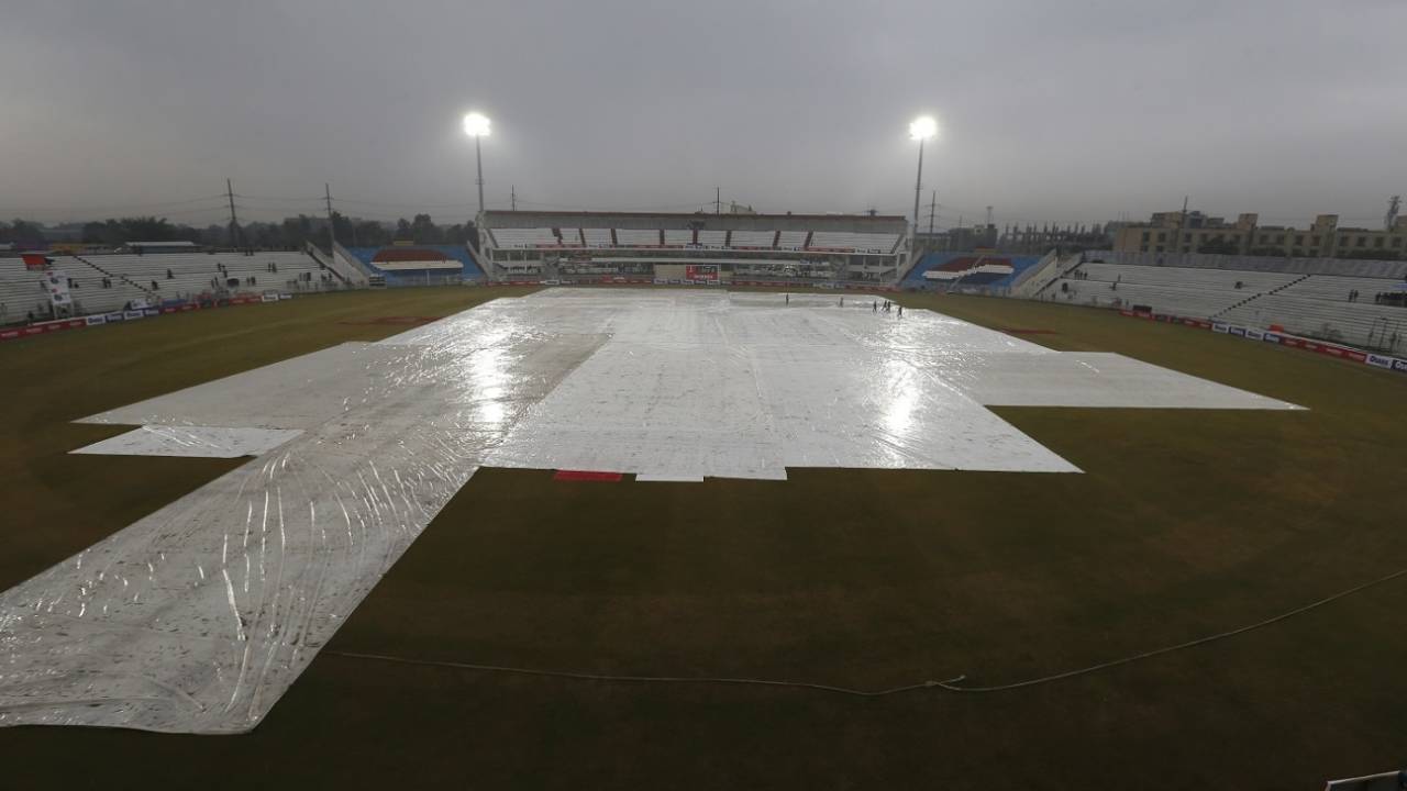 The ground staff keep the pitch and adjacent areas under cover due to rain&nbsp;&nbsp;&bull;&nbsp;&nbsp;Associated Press