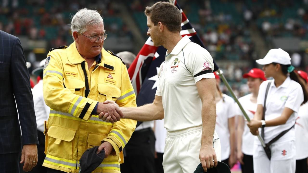 Tim Paine shakes hands with Ku-ring-gai fire brigade volunteer John Corry before the start of the Test&nbsp;&nbsp;&bull;&nbsp;&nbsp;Getty Images