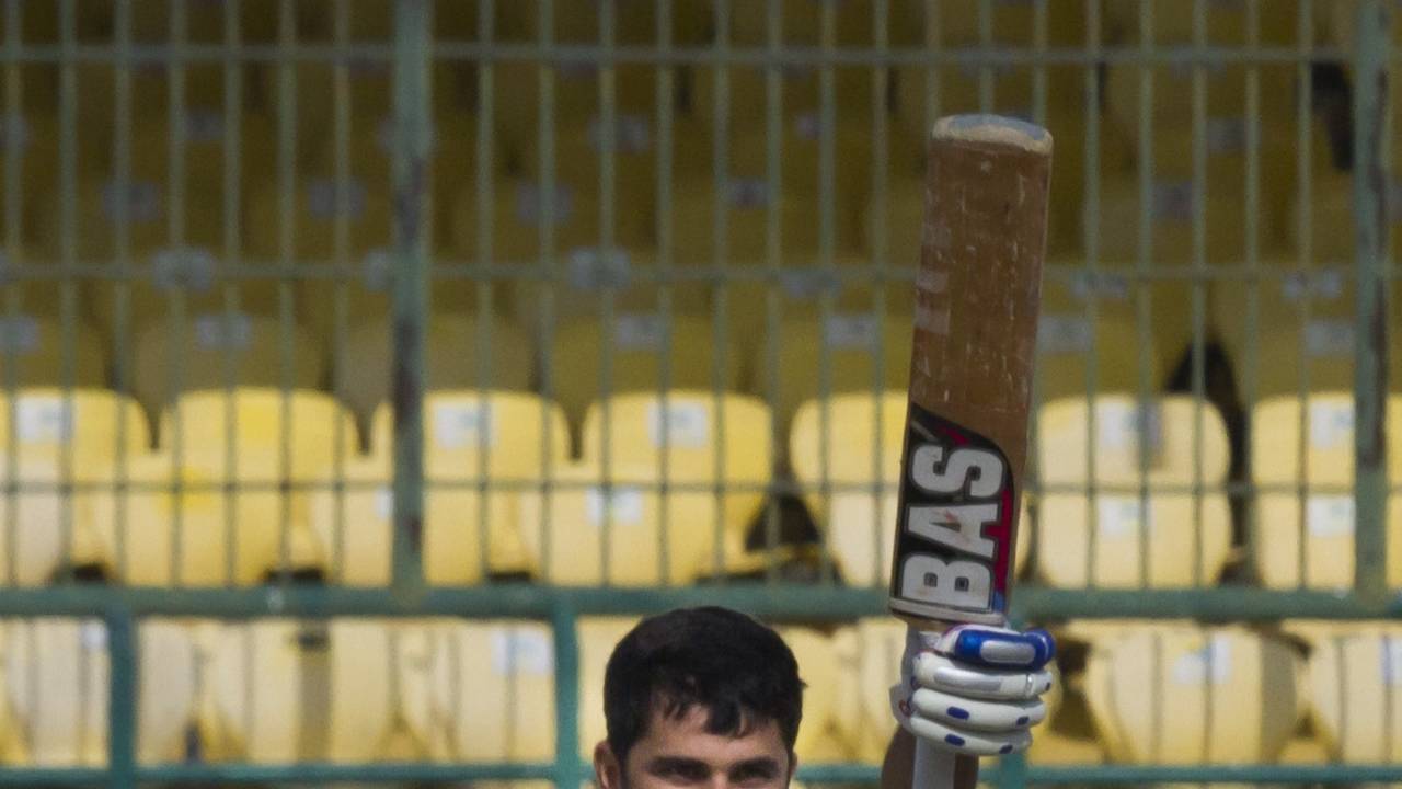 Rameez Khan raises his bat after getting to a century