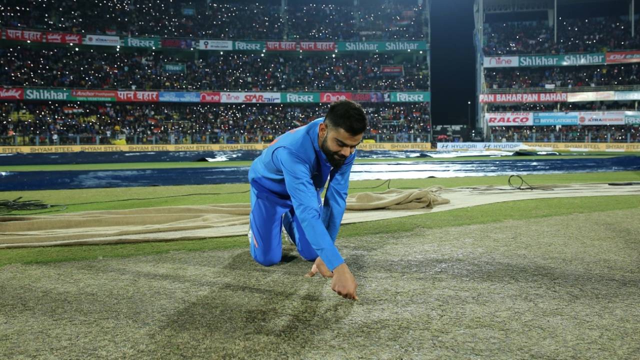 Virat Kohli examines a wet patch on the wicket&nbsp;&nbsp;&bull;&nbsp;&nbsp;BCCI