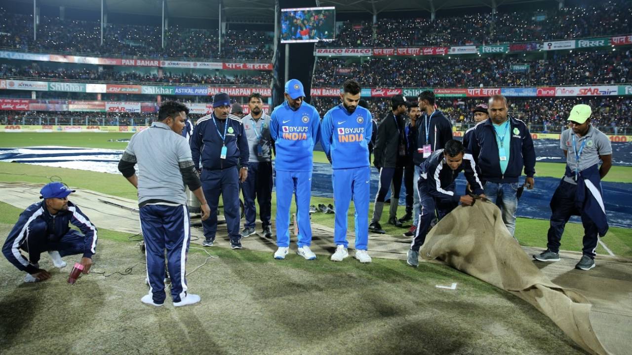 Shikhar Dhawan and Virat Kohli stand pitch side as the groundstaff works on drying the pitch after rain, India v Sri Lanka, 1st T20I, Guwahati, January 5, 2020