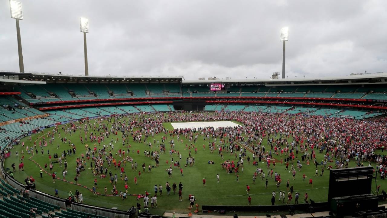 Fans swarm the SCG after the Sixers v Renegades game