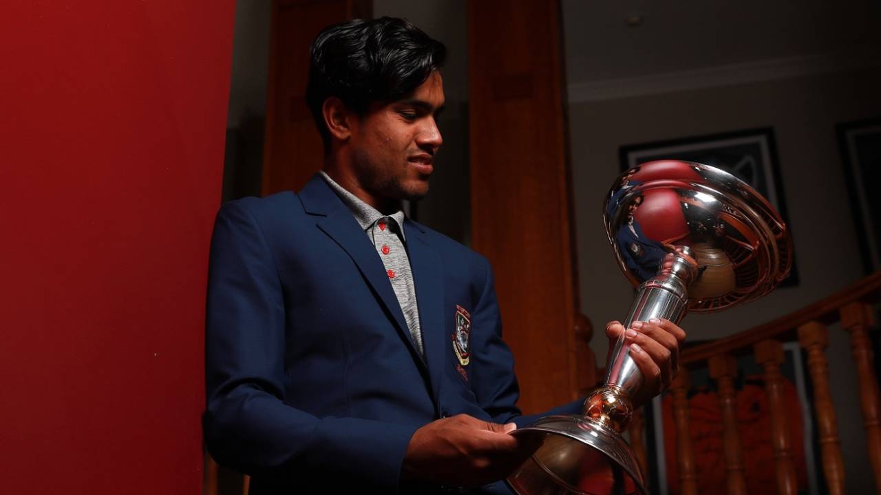 Akbar Ali poses with the World Cup trophy&nbsp;&nbsp;&bull;&nbsp;&nbsp;ICC via Getty