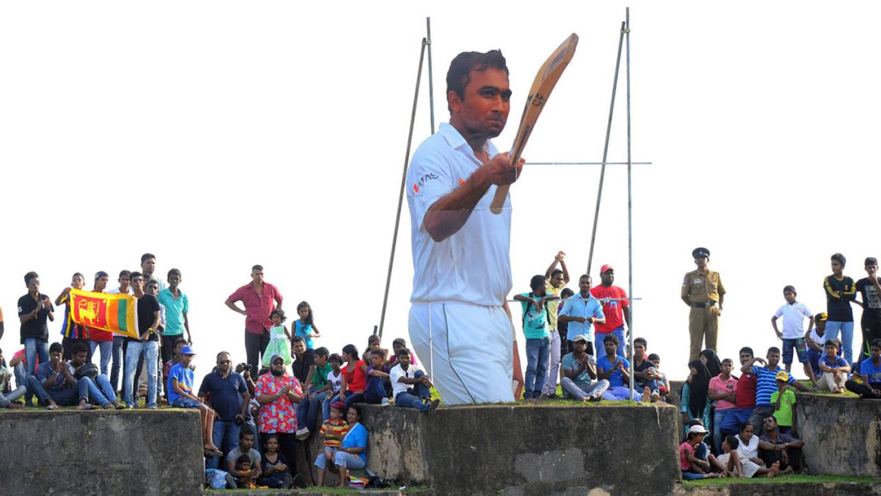Spectators gather to watch the final day's play next to a cut-out of Mahela Jayawardene, Sri Lanka v Pakistan, 1st Test, Galle, 5th day, August 10, 2014